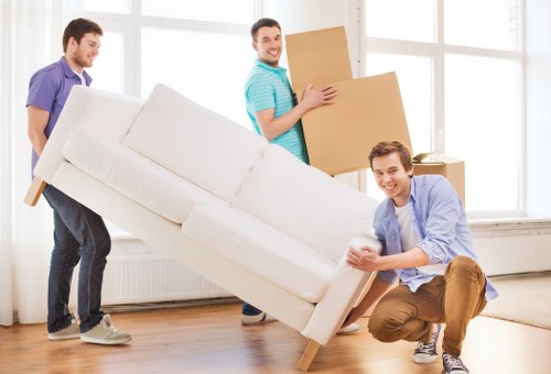 Local movers transporting household items through an East London street