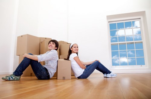 Boxes and furniture being prepared for transport during a man and van move