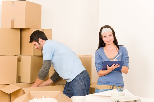 Movers loading items into a van near East London homes